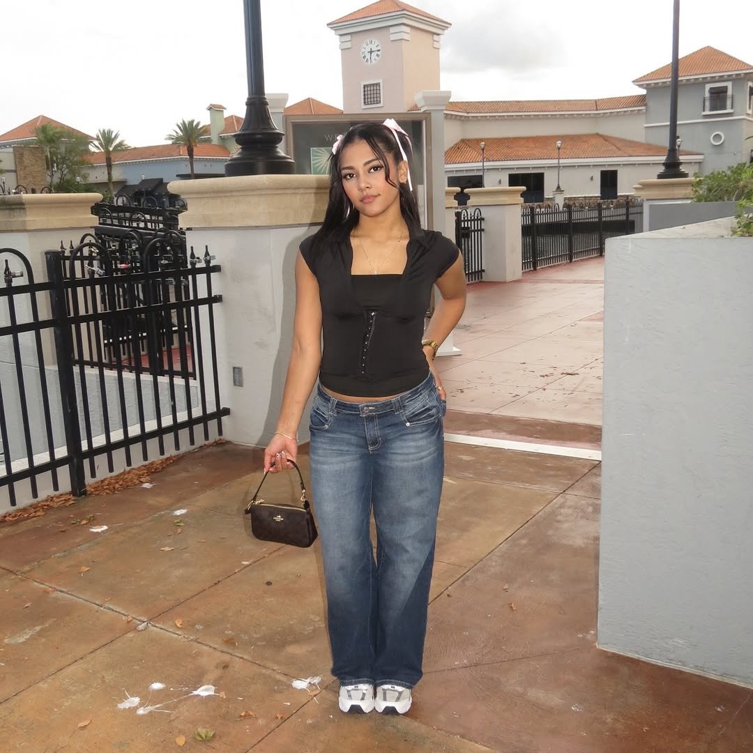 Daniela walking through a plaza in denim
