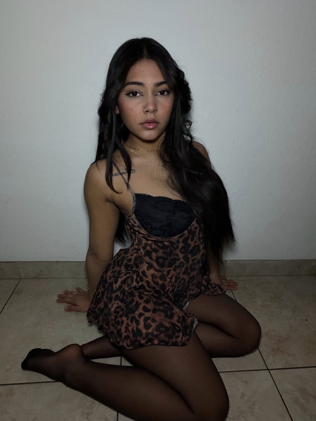 Daniela kneeling in a leopard dress